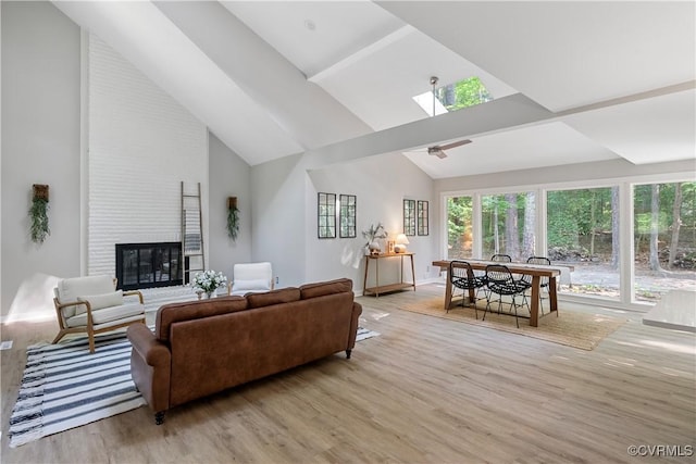4458 Old Fox Trl, Chesterfield, VA 23112 - living area with high vaulted ceiling, light wood-style floors, a fireplace, and a skylight