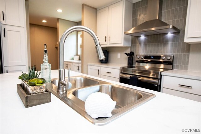 12 Sunset Ln, Rice, VA 23966 - kitchen with wall chimney exhaust hood, stainless steel electric range oven, tasteful backsplash, white cabinetry, and recessed lighting