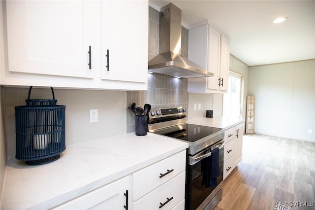 12 Sunset Ln, Rice, VA 23966 - kitchen with stainless steel electric range, wall chimney exhaust hood, light countertops, white cabinetry, and recessed lighting