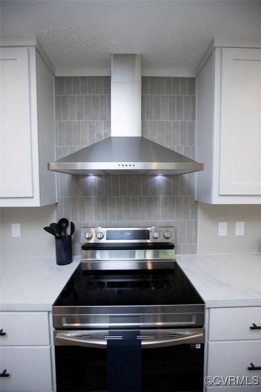 12 Sunset Ln, Rice, VA 23966 - kitchen featuring stainless steel electric range oven, wall chimney exhaust hood, a textured ceiling, white cabinetry, and tasteful backsplash