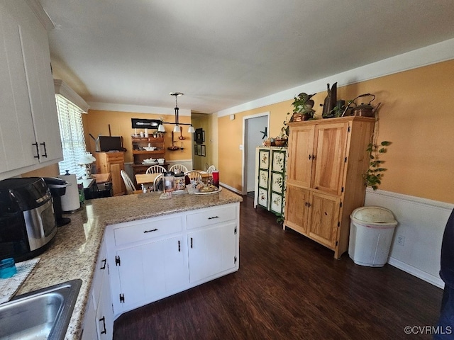 5403 Chesdin Rd, North Dinwiddie, VA 23803 - kitchen with dark wood-style floors, a peninsula, white cabinets, hanging light fixtures, and light stone countertops
