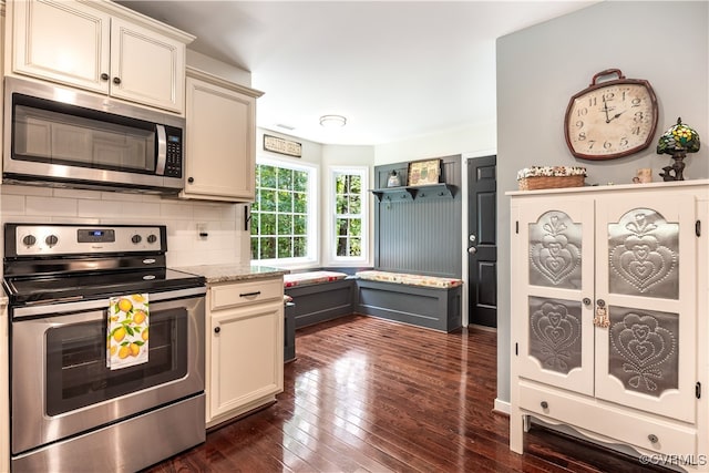 4672 Bell Rd, Powhatan, VA 23139 - kitchen with stainless steel appliances, tasteful backsplash, dark wood-type flooring, and cream cabinetry