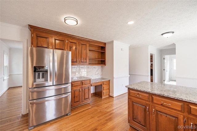 6924 Longview Dr, New Kent, VA 23141 - kitchen featuring stainless steel refrigerator with ice dispenser, open shelves, a textured ceiling, brown cabinets, and tasteful backsplash