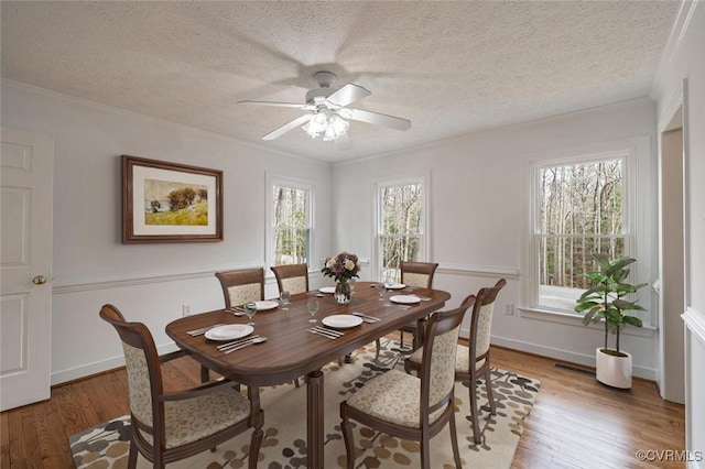 6924 Longview Dr, New Kent, VA 23141 - dining area featuring light wood-type flooring, a ceiling fan, a textured ceiling, and crown molding