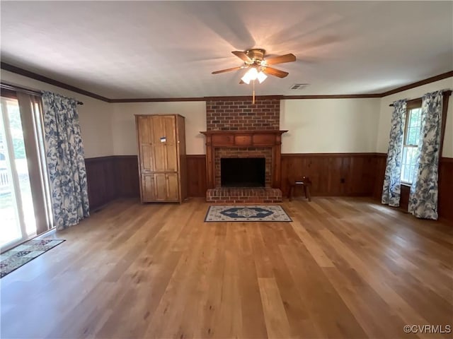 2458 Happy Hill Ln, Mechanicsville, VA 23111 - unfurnished living room with wainscoting, plenty of natural light, a ceiling fan, light wood-style flooring, and crown molding