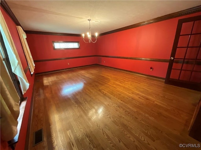 2458 Happy Hill Ln, Mechanicsville, VA 23111 - spare room featuring ornamental molding, a chandelier, and wood finished floors