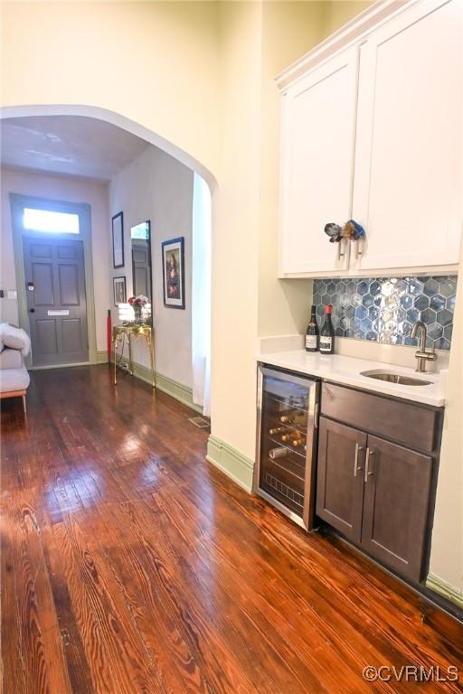 7 N Davis Ave, Richmond, VA 23220 - indoor bar with beverage cooler, backsplash, dark wood-type flooring, and arched walkways