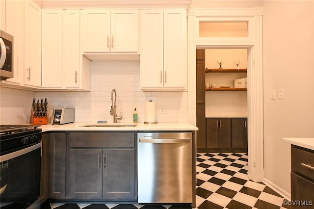 7 N Davis Ave, Richmond, VA 23220 - kitchen with appliances with stainless steel finishes, tile patterned floors, light countertops, and backsplash