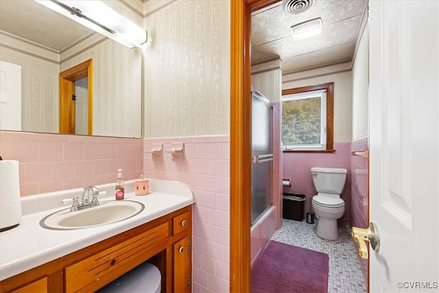 4312 Erlene Ct, Chester, VA 23831 - full bath featuring tile walls, vanity, wainscoting, wallpapered walls, and shower / bath combination with glass door