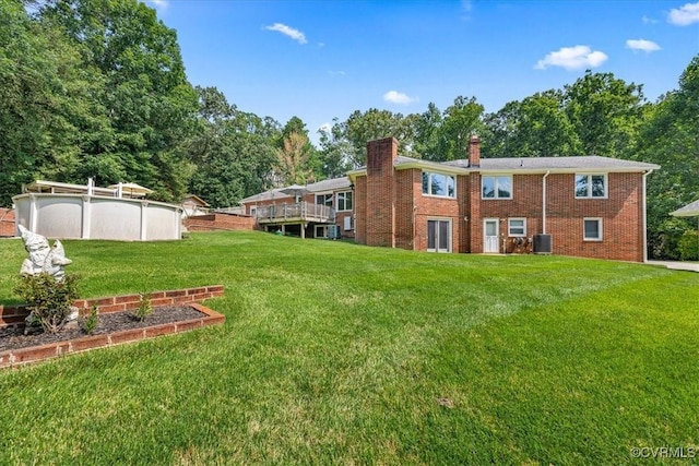 4312 Erlene Ct, Chester, VA 23831 - back of property with a chimney, a lawn, an outdoor pool, and brick siding