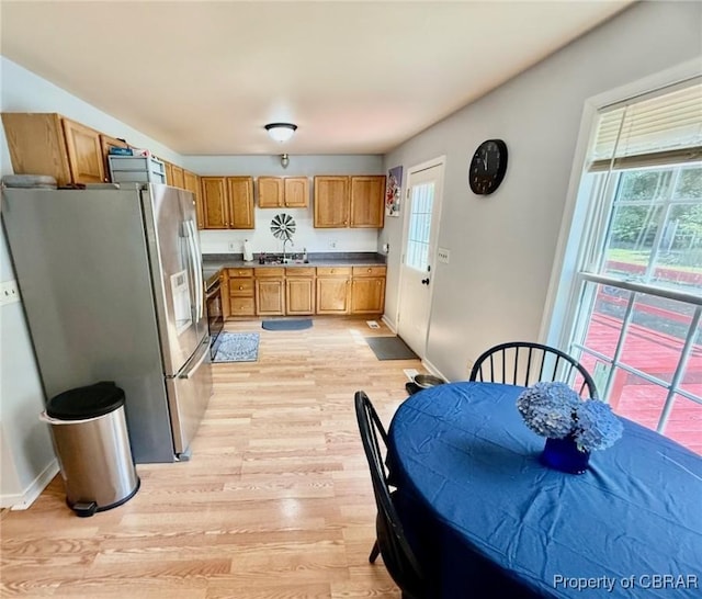 162 Twin Oaks Rd, Water View, VA 23180 - kitchen with stainless steel fridge, light wood finished floors, healthy amount of natural light, and brown cabinetry