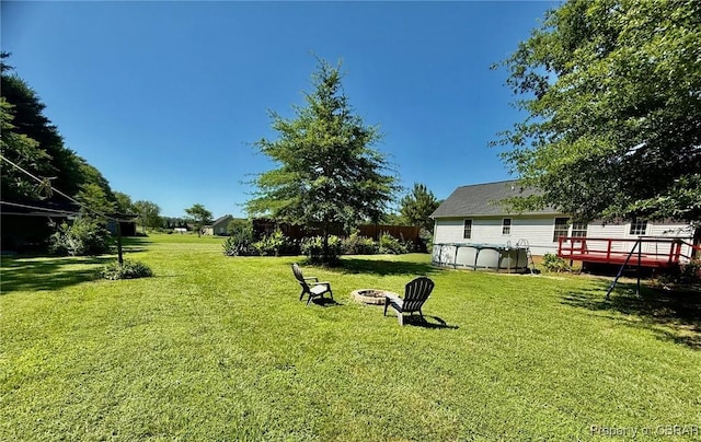162 Twin Oaks Rd, Water View, VA 23180 - view of grassy yard with an outdoor fire pit and a wooden deck