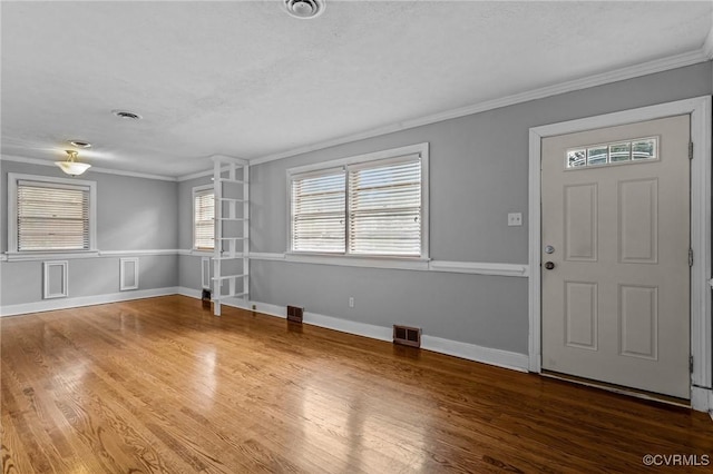 3205 Birchbrook Rd, Henrico, VA 23228 - foyer entrance with crown molding, healthy amount of natural light, wood finished floors, and wainscoting