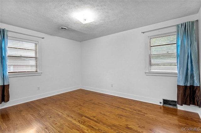 3205 Birchbrook Rd, Henrico, VA 23228 - spare room featuring a textured ceiling and wood finished floors