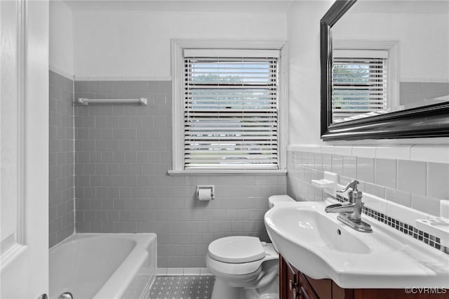 3205 Birchbrook Rd, Henrico, VA 23228 - full bathroom featuring tile walls, vanity, tile patterned floors, plenty of natural light, and wainscoting