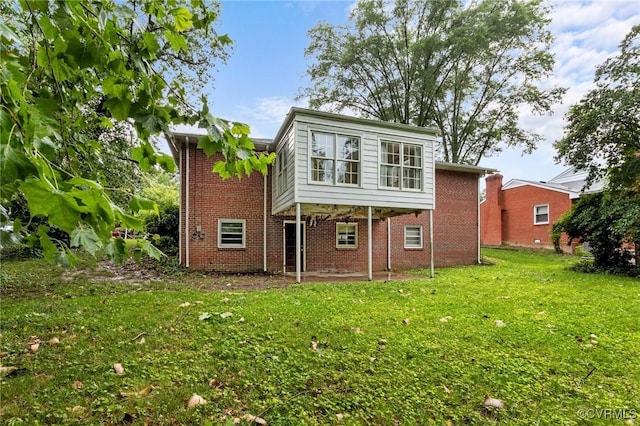 3205 Birchbrook Rd, Henrico, VA 23228 - back of house with brick siding and a yard