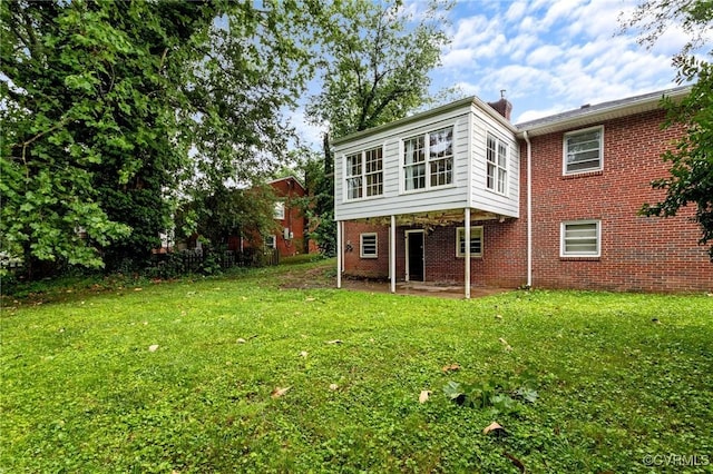 3205 Birchbrook Rd, Henrico, VA 23228 - back of property with a lawn, a patio area, brick siding, and a chimney