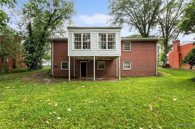 3205 Birchbrook Rd, Henrico, VA 23228 - back of house with a patio, a lawn, and brick siding
