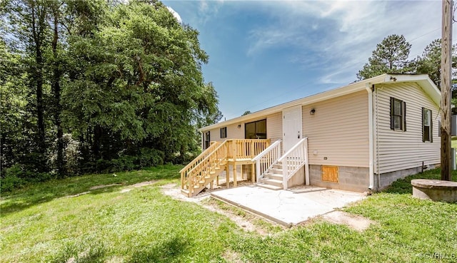 21113 River Rd, Dinwiddie, VA 23885 - back of property featuring a yard and a patio area