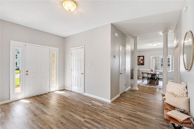 6118 Pond Grass Rd, Mechanicsville, VA 23111 - foyer with decorative columns, wood finished floors, and a textured ceiling