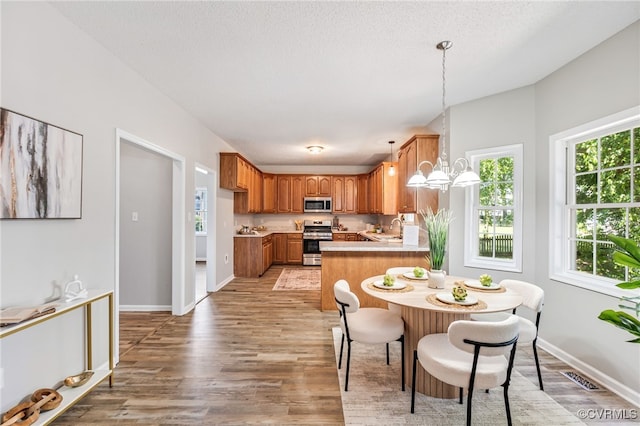 6118 Pond Grass Rd, Mechanicsville, VA 23111 - dining room with healthy amount of natural light, light wood finished floors, and a chandelier