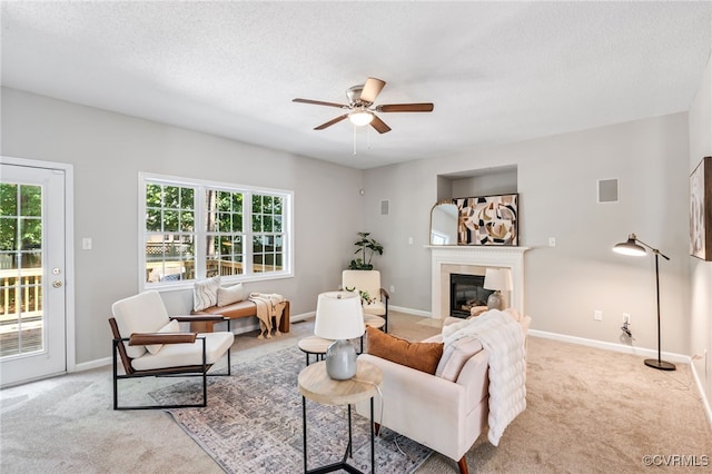 6118 Pond Grass Rd, Mechanicsville, VA 23111 - living area with carpet, a ceiling fan, healthy amount of natural light, a fireplace with flush hearth, and a textured ceiling
