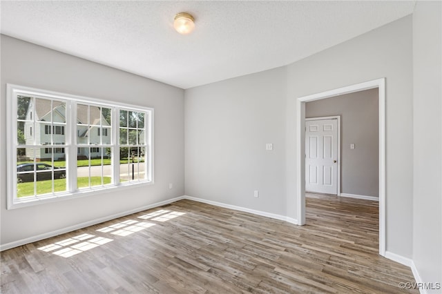 6118 Pond Grass Rd, Mechanicsville, VA 23111 - empty room featuring wood finished floors and a textured ceiling
