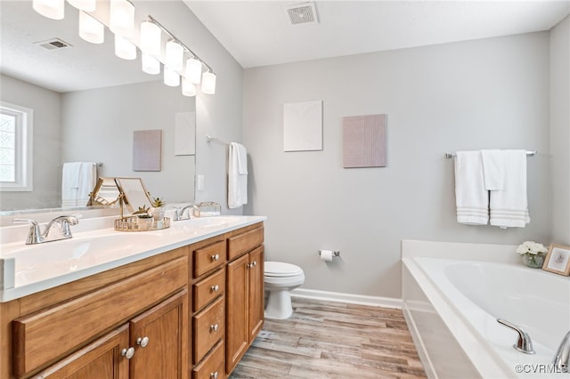 6118 Pond Grass Rd, Mechanicsville, VA 23111 - full bath featuring double vanity, a garden tub, and wood finished floors