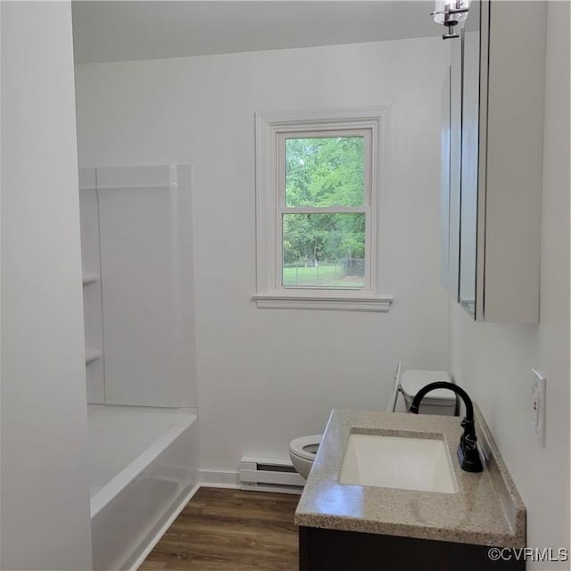 3017 Wright Rd, Petersburg, VA 23805 - bathroom with a baseboard radiator, vanity, wood finished floors, and bathtub / shower combination