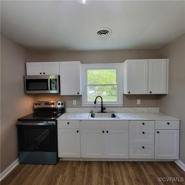 3017 Wright Rd, Petersburg, VA 23805 - kitchen featuring stainless steel appliances, dark wood finished floors, white cabinets, and light stone counters