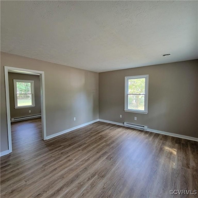 3017 Wright Rd, Petersburg, VA 23805 - empty room featuring baseboard heating, dark wood finished floors, and a textured ceiling