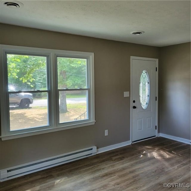 3017 Wright Rd, Petersburg, VA 23805 - entrance foyer featuring a baseboard heating unit, dark wood finished floors, and plenty of natural light