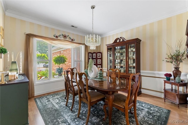 9316 Crossover Dr, Mechanicsville, VA 23116 - dining room with a chandelier, ornamental molding, wallpapered walls, light wood-type flooring, and wainscoting