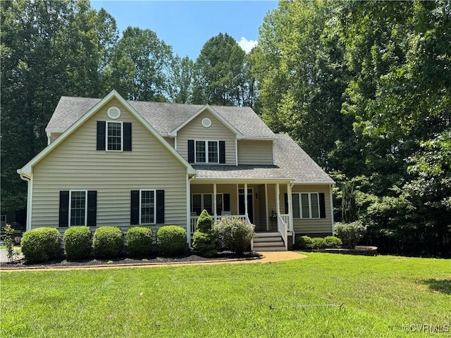2669 Dorset Meadows Dr, Powhatan, VA 23139 - view of front facade with covered porch, a front yard, and roof with shingles