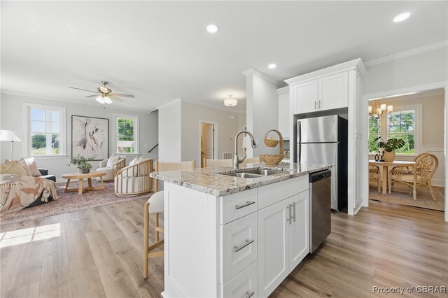 113 Goffigans Trce, Yorktown, VA 23693 - kitchen featuring stainless steel appliances, ornamental molding, open floor plan, light stone counters, and white cabinets