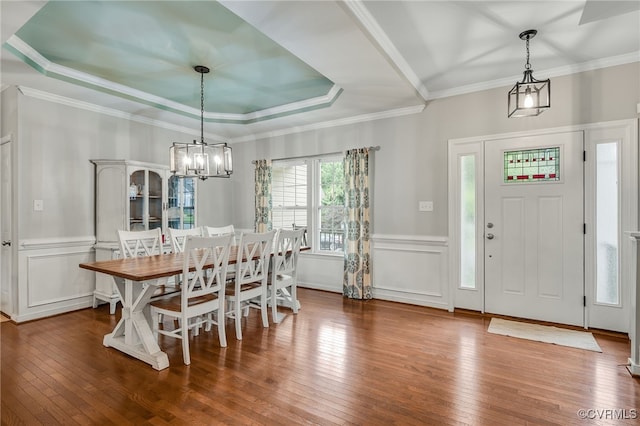 14919 Bayfront Pl, Midlothian, VA 23112 - dining room featuring a chandelier, wood-type flooring, a wainscoted wall, a decorative wall, and a raised ceiling