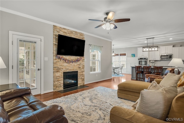 14919 Bayfront Pl, Midlothian, VA 23112 - living room featuring crown molding, ceiling fan, a stone fireplace, wood finished floors, and recessed lighting