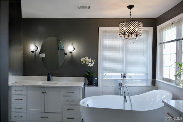 43314 Fullerton St, Ashburn, VA 20147 - full bathroom featuring vanity, a soaking tub, and a chandelier