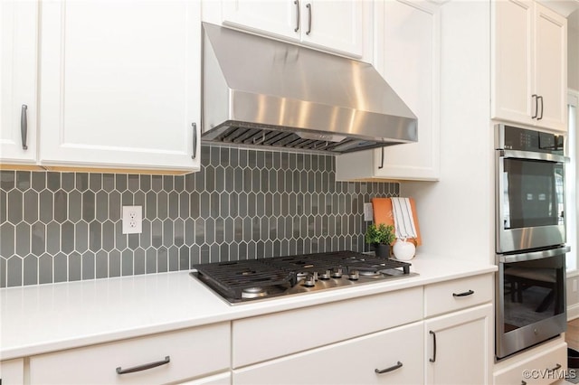 5024 Rivermere Ln, Glen Allen, VA 23059 - kitchen featuring under cabinet range hood, appliances with stainless steel finishes, and white cabinetry