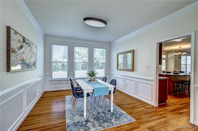 5408 Woolshire Dr, Glen Allen, VA 23059 - dining room with a chandelier, ornamental molding, wood finished floors, a decorative wall, and a wainscoted wall