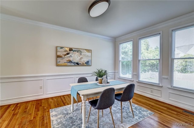 5408 Woolshire Dr, Glen Allen, VA 23059 - dining space featuring ornamental molding, a decorative wall, wood finished floors, and wainscoting