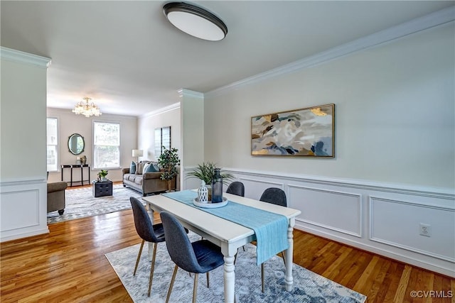 5408 Woolshire Dr, Glen Allen, VA 23059 - dining space featuring ornamental molding, a chandelier, wood finished floors, a decorative wall, and wainscoting