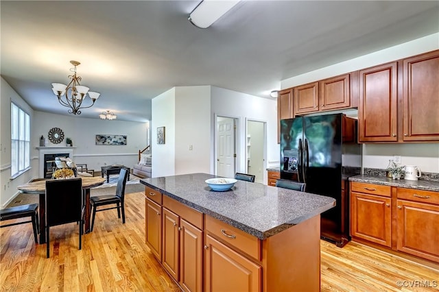 5408 Woolshire Dr, Glen Allen, VA 23059 - kitchen featuring black fridge with ice dispenser, dark countertops, light wood-type flooring, a kitchen island, and a chandelier