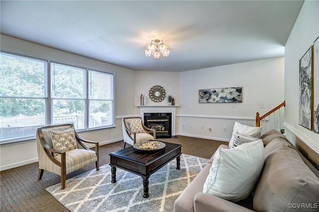 5408 Woolshire Dr, Glen Allen, VA 23059 - living area featuring dark colored carpet, a chandelier, and a fireplace with flush hearth