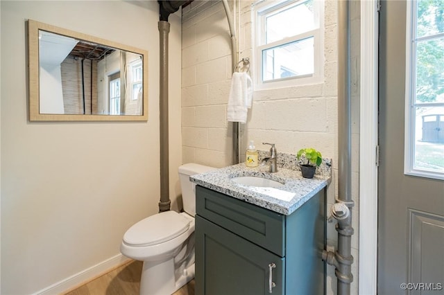 4205 W End Dr, Henrico, VA 23294 - bathroom featuring vanity, concrete block wall, and wood finished floors