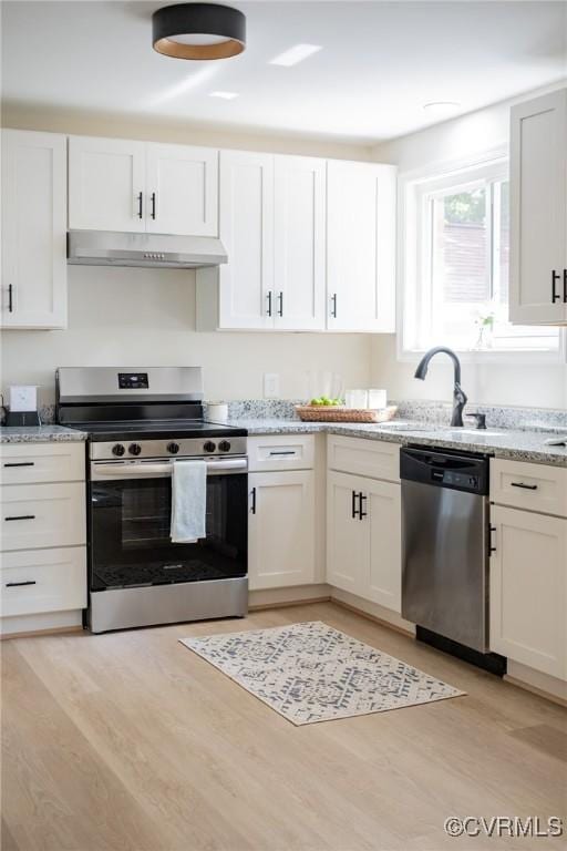 4205 W End Dr, Henrico, VA 23294 - kitchen featuring appliances with stainless steel finishes, under cabinet range hood, light wood finished floors, and white cabinets