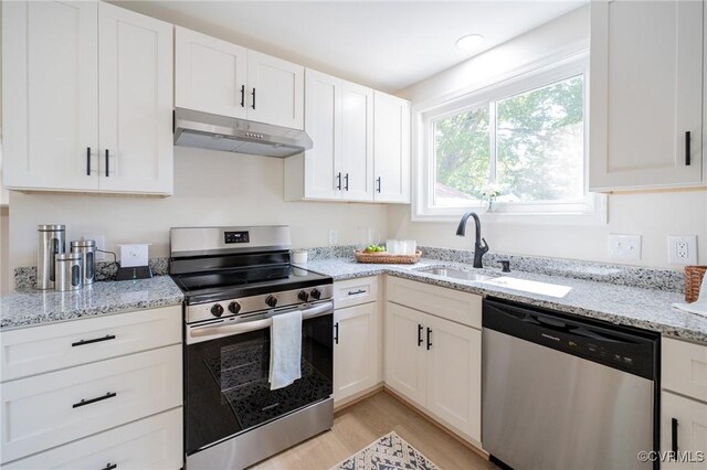 4205 W End Dr, Henrico, VA 23294 - kitchen with appliances with stainless steel finishes, under cabinet range hood, light wood-type flooring, white cabinets, and light stone countertops