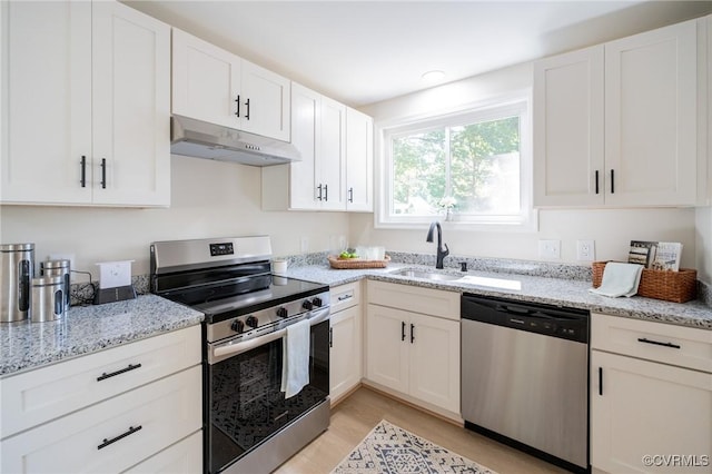 4205 W End Dr, Henrico, VA 23294 - kitchen with appliances with stainless steel finishes, under cabinet range hood, white cabinets, light stone countertops, and light wood-style floors
