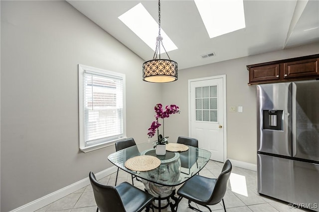 9286 Hungary Rd, Glen Allen, VA 23060 - dining space featuring a skylight, light tile patterned floors, and lofted ceiling