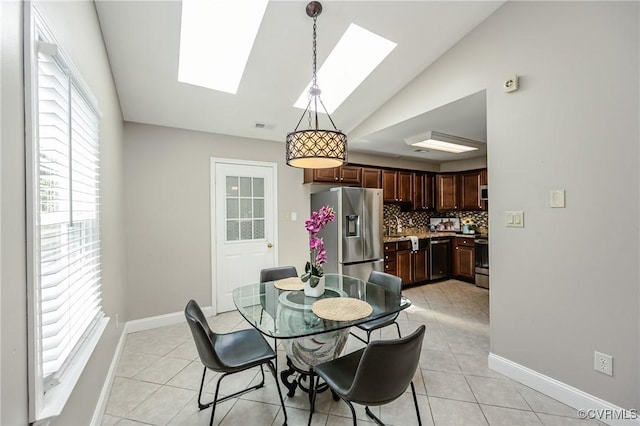 9286 Hungary Rd, Glen Allen, VA 23060 - dining room featuring vaulted ceiling, light tile patterned floors, and a skylight